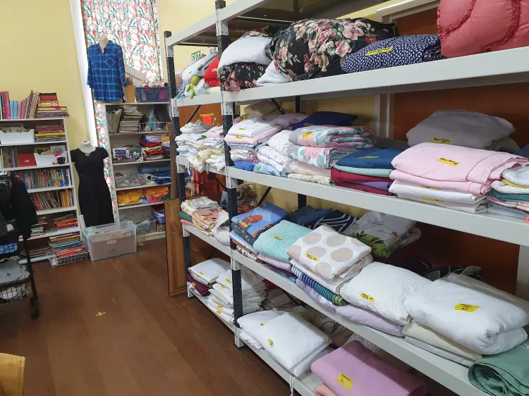 Shelves of neatly folded blankets and bedding