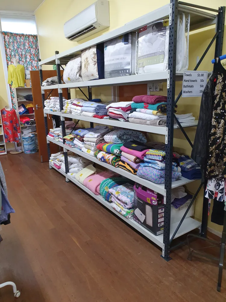 Shelves of folded linen, towels and blankets for sale